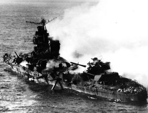 "Japanese heavy cruiser Mikuma, photographed from a USS Enterprise (CV-6) SBD aircraft during the Battle of Midway, after she had been bombed by planes from Enterprise and USS Hornet (CV-8). Note her shattered midships structure, torpedo dangling from the after port side tubes and wreckage atop her number four eight-inch gun turret." Date6 June 1942 Source Official U.S. Navy Photograph 80-G-414422, now in the collections of the National Archives.
