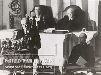  President Franklin Delano Roosevelt delivers his "Day of Infamy" speech to Congress on December 8, 1941. Behind him are Vice President Henry Wallace (left) and Speaker of the House Sam Rayburn. To the right, in uniform in front of Rayburn, is Roosevelt's son James, who escorted his father to the Capitol.