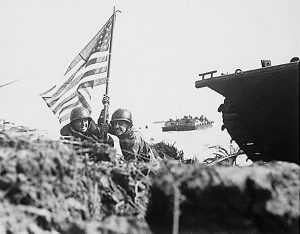Two U.S. officers plant the American flag on Guam eight minutes after U.S. Marines and Army assault troops landed