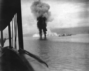 Smoke rises from two Japanese planes shot down during the Naval Battle of Guadalcanal, 12 November 1942. Photographed from USS President Adams (AP-38); ship at right is USS Betelgeuse (AK-28).