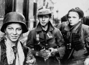 Warsaw Uprising: Soldiers from the "Radosław Regiment" after several hours marching through sewers from Krasiński Square to Warecka Street in the Śródmieście district, early morning on September 2, 1944. The boy in helmet is Tadeusz "Maszynka" Rajszczak from the Miotła Battalion.