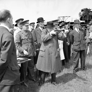 English: Photo No.: H 10688 Photographer: Horton (Capt)War Office official photographer Collection Title: WAR OFFICE SECOND WORLD WAR OFFICIAL COLLECTION Collection No.: 4700-37 Description: WINSTON CHURCHILL AS PRIME MINISTER 1940-45 Winston Churchill takes aim with a Sten gun during a visit to the Royal Artillery experimental station at Shoeburyness in Essex, 13 June 1941. Period: 5 Second World War Date: 13 June 1941. - Copyright: Crown copyright Access: Unrestricted Colour / B&W:Black and white Type:Official photograph Note: the man in a pin-striped suit on the right of Churchill is Walter Thompson, Churchill's bodyguard.
