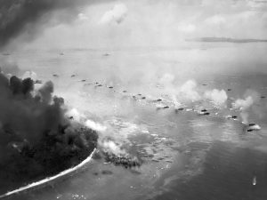 The first wave of LVTs moves toward the invasion beaches, passing through the inshore bombardment line of LCI gunboats. Cruisers and battleships are bombarding from the distance. The landing area is almost totally hidden in dust and smoke. Photographed from a USS Honolulu (CL-48) plane. Date September 15, 1944. Source - National Park Service - (Naval Historical Center, US Navy 80-G-283553)