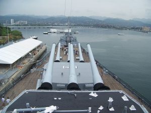 The USS Missouri (BB-63) watching over the sunken USS Arizona (BB-39) in Pearl Harbor.