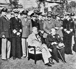 Casablanca-Conference - Seated: President Roosevelt and Prime Minister Churchill. Standing, front row, left to right: General Arnold, Admiral King, General Marshall, Admiral Pound, Air Chief Marshal Portal, General Brooke, Field Marshal Dill, and Admiral Mountbatten. January 1943.