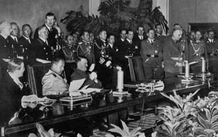 Signing ceremony for the Axis Powers Tripartite Pact; seated at front left (left to right) are Japan's Ambassador Saburō Kurusu (leaning forward), Italy's Minister of Foreign Affairs Galeazzo Ciano and Germany's Führer Adolf Hitler (slumping in his chair).