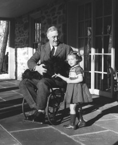 Franklin D. Roosevelt, Fala and Ruthie Bie at Hill Top Cottage in Hyde Park, N.Y. The better of two extant photos of FDR in a wheel chair. February 1941