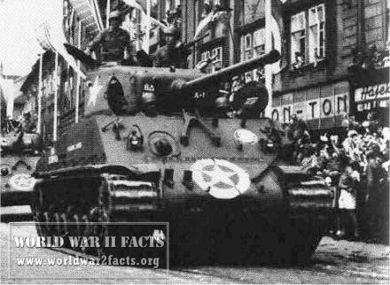 M4A3E8 participating in a World War II victory parade has front armor flat against both crew hatches compared to others that protruded above sloping armor.