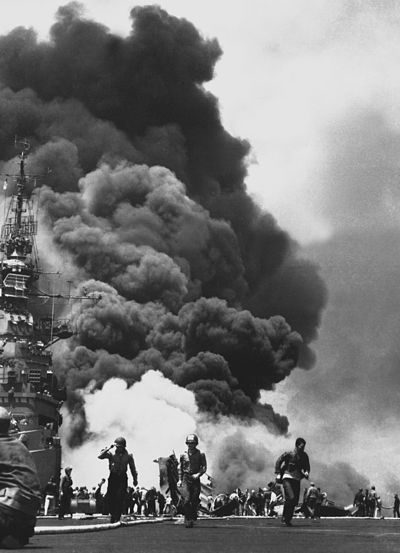 American aircraft carrier USS Bunker Hill burns after being hit by two kamikaze planes within 30 seconds.